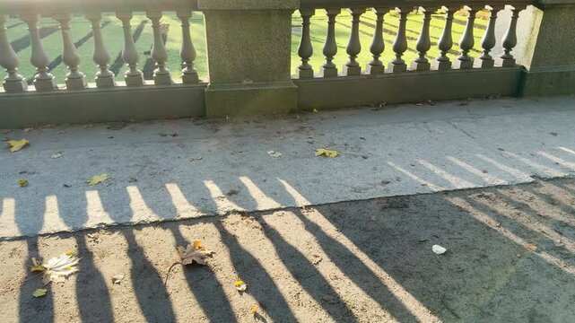 Tracking shot of an empty balustrade on gimbal in Catherine Park, Pushkin, Saint Petersburg. Smooth sideways camera movement, no people, evoking peaceful, serene feelings.