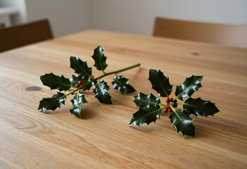 Fototapeta premium Christmas holiday decoration, holly sprigs with red berries on a wooden table for festive winter season home interior and seasonal celebration