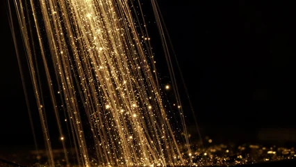 Golden light beams cascade down, sparkling like stars against a dark backdrop. © YiuCheung