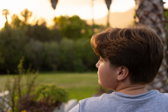 portrait of 13 year old boy at moment of sunset