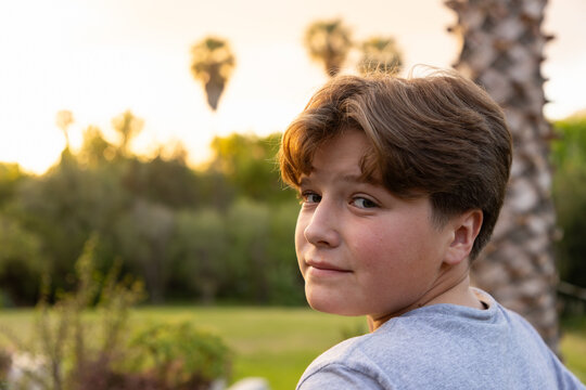 portrait of 13 year old boy at moment of sunset