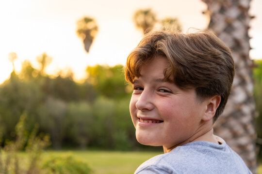 close up portrait of 13 year old boy at moment of sunset
