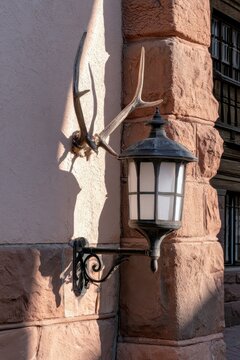 Wall Lantern and Deer Antlers on Stone Building