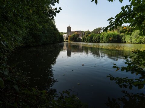 Perfect water reflection of historic Kost castle and autumn trees