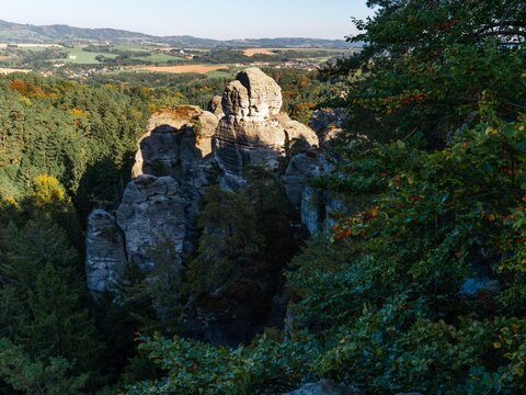Massive sandstone rock blocks under clear blue sky in autumn