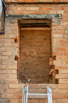 Reinforcing a brick wall opening with a steel lintel and support structure