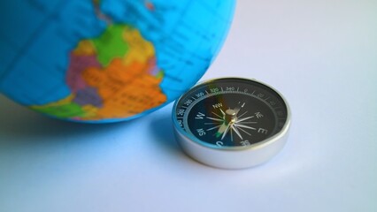 Magnetic Compass with Planet Earth Globe Travel Navigation Concept Close Up © Yosep