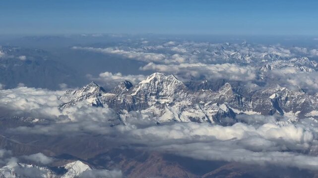 Snow-Covered Hindu Kush Peak Rising Above Cloud Bands in Afghanistan