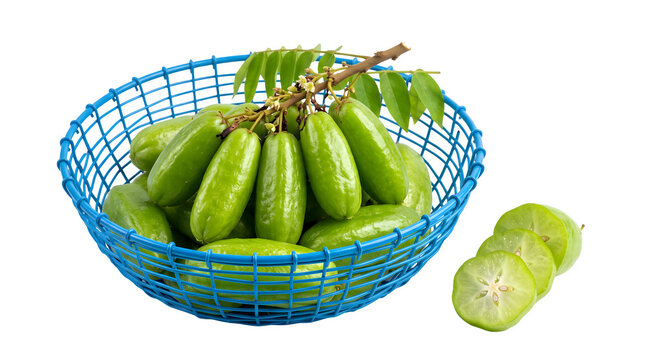Fresh bilimbi fruits in a blue basket with sliced pieces on a black background