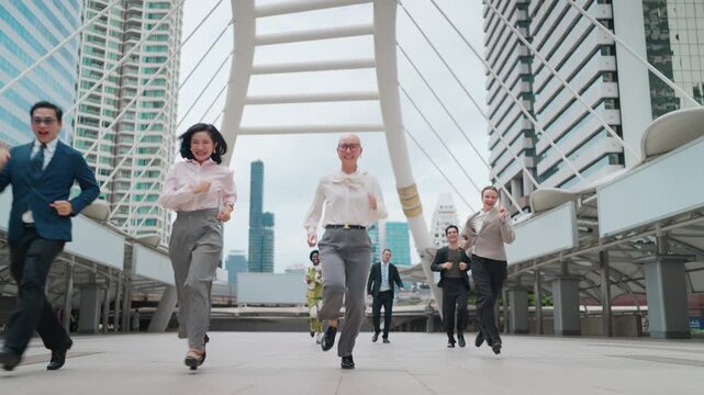 Business professionals rush across a modern urban bridge. Urban skyline looms behind their swift movement