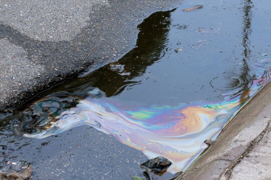 Iridescent oil slick on water surface