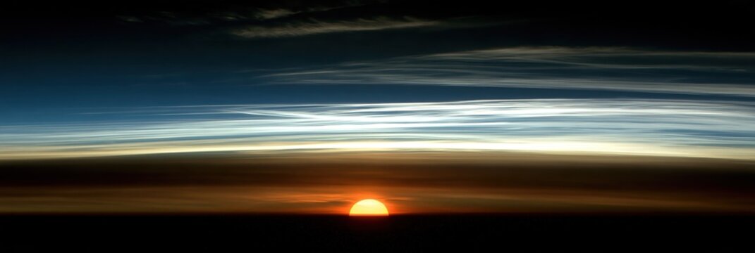 Sunrise or sunset over Earth's atmosphere with clouds