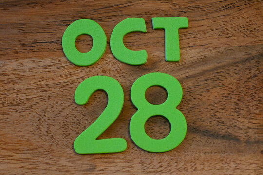 October 28 lettering on a wooden surface