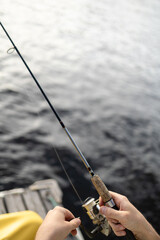Fototapeta premium First person point of view of fishing from a wooden dock