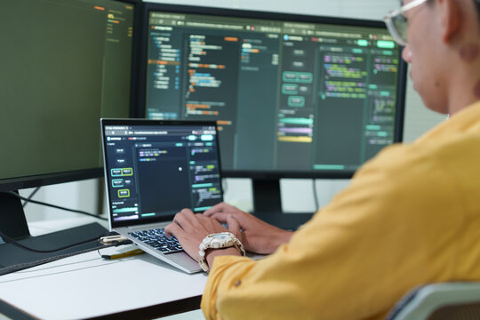 Software developer programming on a laptop computer