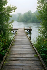 Fototapeta premium Solitude and mindfulness, wooden pier extending into a calm misty river with lush green trees and peaceful nature scenery for wellness and relaxation