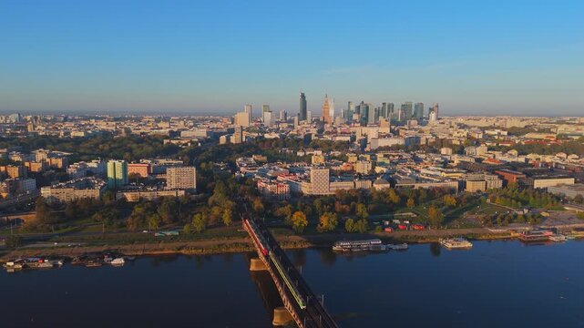 Aerial Drone View of Warsaw City Center and Vistula River at Sunrise with Cable-Stayed Bridge