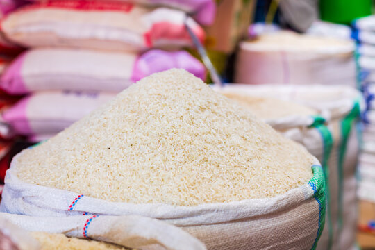 white rice in sack on display for sale at a local market in Dar es Salaam, Tanzania. Food security and agriculture concept