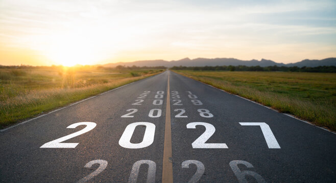 New year 2027 or start straight concept.word 2027 written on the road in the middle of asphalt road at sunset.Concept of planning and challenge or career path,business strategy,opportunity and change