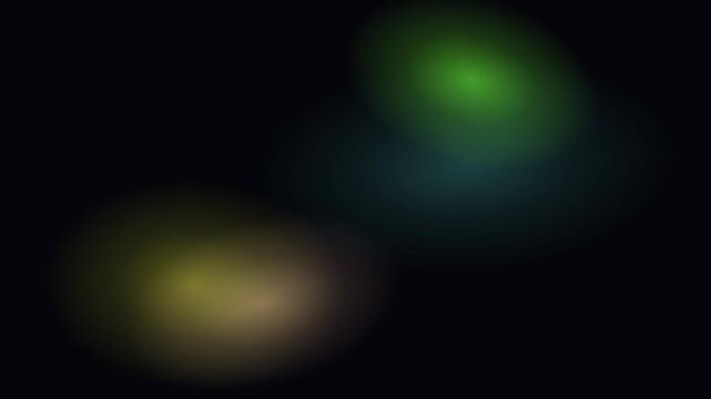 Out of focus glowing orbs of color floating against a pitch black background