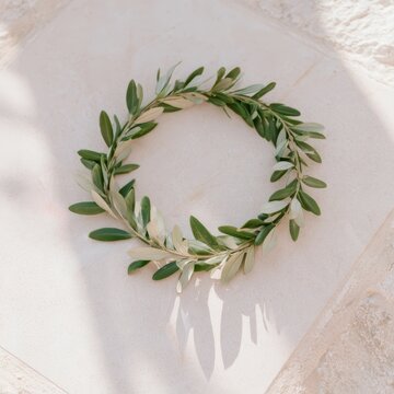 Olive branch wreath on textured surface