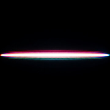 Phosphor light streaks mimicking particle trail on black background