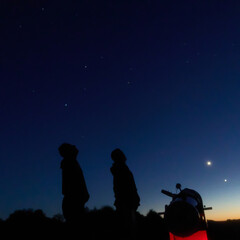 Fototapeta premium Amateur astronomers observing stars, planets, Moon and other celestial objects with a telescope in nature.
