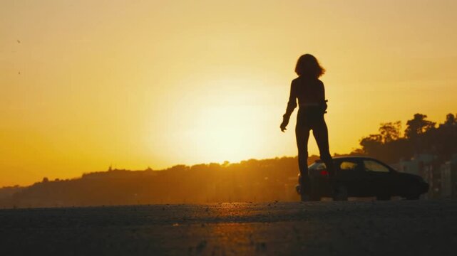 Silhouette Of Woman Rollerblading Outdoors At Sunset