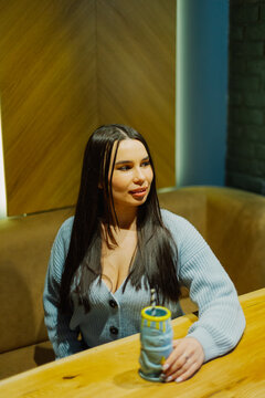 Beautiful young woman sitting at a table in a cafe