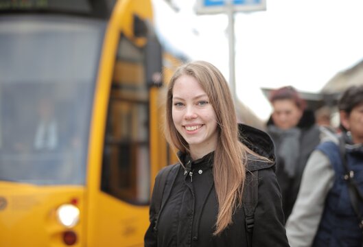 young woman in a tram stop station