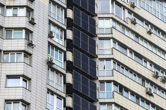Solar panels and a battery storage system mounted on a modern apartment building in Kyiv, Ukraine, providing renewable energy and backup power for residential use.