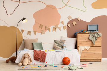Childhood development and messy bedroom, playful interior design with toys and clothes in a cozy kids room with abstract wall mural and bunting © Pixel-Shot