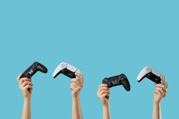 Gaming community and esports competition, diverse hands holding modern video game controllers for multiplayer entertainment on a blue background © Pixel-Shot
