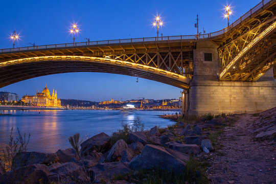 Margit Bridge arch over the Danube with Hungarian Parliament at blue hour, Budapest, Hungary