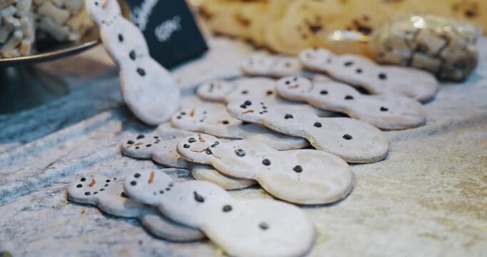 A few snowman cookies decorations at Christmas market in Cologne, Germany. They are arranged in a row on a white table