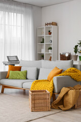 Home comfort and interior design, cozy living room with grey sofa and yellow knitted blanket for relaxation and lifestyle living in a modern apartment © Pixel-Shot