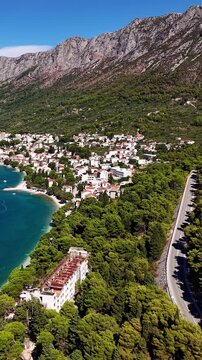 Croatia, aerial footage of the coastal highway running alongside the Adriatic Sea, mountains, and town