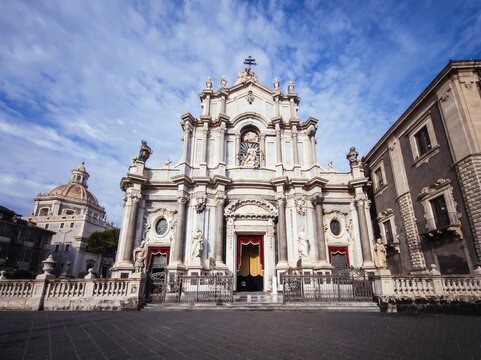 Mediterranean travel photograph capturing the Church of San Francesco d'Assisi all'Immacolata with Badia di Sant'Agata in the background, ideal for Sicilian travel guidebooks and urban tourism media.