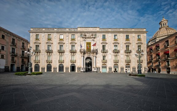 Vibrant Mediterranean travel photograph capturing the iconic University Palace in Piazza Universit&agrave; in Catania, ideal for educational guidebooks, architectural collections, and Sicilian tourism media.