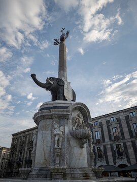 Low-angle photograph of the historic Fontana dell'Elefante monument in Piazza del Duomo, Catania, Sicily, Italy.