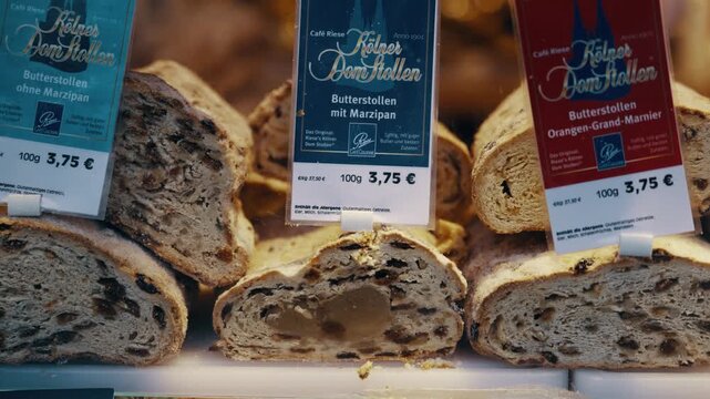 A display of stollen fruit bread with a sign that says "Kiekerl Bockbatter" at Christmas market in Germany