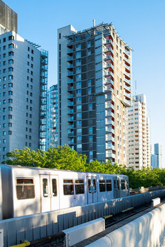 Urban train passes modern residential towers in Vienna Austria linking rail transport with contemporary housing across the city in this architecture view