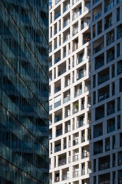 Modern facades create architecture in Vienna Austria with dark reflective glass beside a white high rise building across this contrasting city view