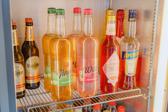 Bad Hersfeld, Germany, 08.15.26. warsteiner beer bottles displayed on a refrigerator shelf in a fresh and organized interior setting with plastic bottles and metal shelf materials, close-up view.