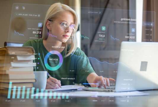Blonde girl in glasses working with notebook and drinking a coffee at home as freelancer