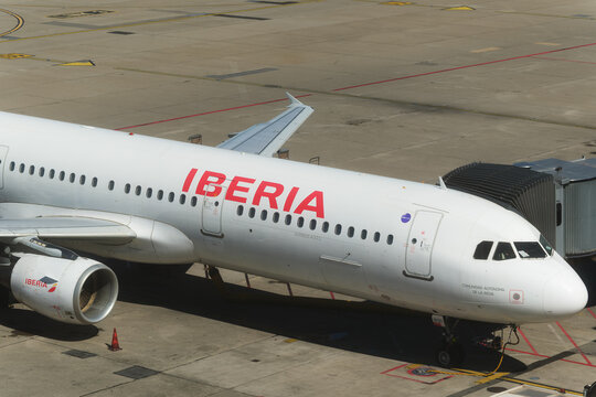 Geneva, Switzerland - september 19, 2026: sign and logo on An Iberia Airbus commercial airliner hooked to a pushback tractor at the gate bridge at Geneva Airport, Switzerland.