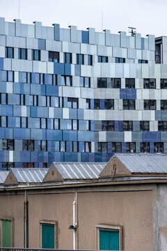 Modern office building rises behind an older urban structure in Paris France showing architectural contrast across the city in this exterior view