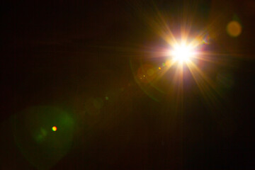 Plakat Sun flare on the black background