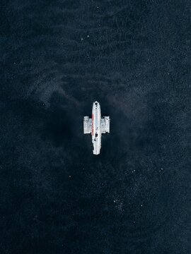 Aerial view of the abandoned DC-3 plane wreck isolated on the vast black sand beach of Solheimasandur in Skeidflotur, Myrdalshreppur, Iceland.