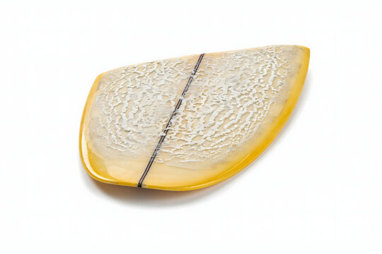 A yellow surfboard with a textured white wax pattern on the deck, featuring a black center stringer, isolated on a plain white background surface